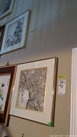 Wide view of both framed prints hung on the wall, showing relative size and placement.