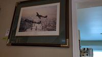 Framed 'Victory Salute' print hanging on a wall