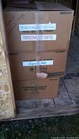 Stacked cardboard boxes labeled 'stuffed animals toys' containing the lot items