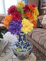 Front view of vase filled with multicolor faux florals