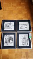 Four framed, signed black and white prints by Arthur De Sousa laid on floor, showing overall condition and frame scratches