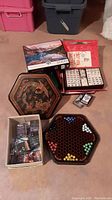 Overview of entire game lot showing puzzle, Mah-Jong box, card games, and Chinese checkers board
