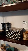 Shelf with lacquer box featuring mother of pearl inlay, marble mortar and pestle, black salt and pepper shakers