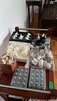 Overview image showing assorted napkin rings, place card holders, and salt shakers on a wooden table.