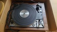 Turntable in cardboard packing box with power cord and cables
