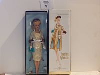 Barbie Evening Splendor doll in original box with visible gold brocade dress and fur coat, white gloves, turquoise handbag, and headband, alongside box artwork.