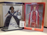 Both dolls in original boxes side by side: Barbie Millennium Princess in blue and white gown, Barbie 2000 in red gown with white stole.