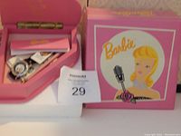 Barbie watch in original pink heart-shaped box with Barbie artwork on lid and assorted papers inside