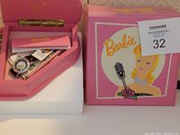 Pink heart-shaped box with Barbie branding containing the watch, stylus, and paperwork