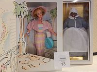 Photo showing Barbie World doll in pastel striped dress, pink hat and jacket, holding a blue handbag, next to Summer Sophisticate doll in gray bonnet and apron, both new in boxes.