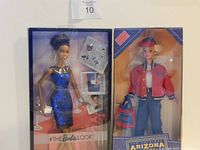 Photo showing two boxed Barbie dolls, one from The Look series in blue dress and one Barbie Arizona Doll in red jacket and blue pants