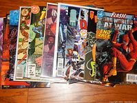 Photo showing a fan spread of about 12 comic books featuring various superhero characters mainly from DC Comics and others.