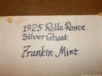 Close-up image of a handwritten label showing '1925 Rolls-Royce Silver Ghost Franklin Mint' confirming model and maker.