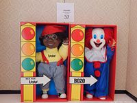 Photo showing both Bozo The Clown and Lester dolls in their colorful original boxes