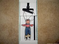 Overview of Howdy Doody marionette puppet in original box, showing full puppet and control stick.