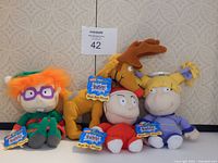 Five new with tags Nickelodeon Rugrats plush toys featuring Chuckie, Spike, Phil, Lil, and Angelica
