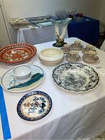 A view of all items displayed on a table including vases, plates, espresso set, and bowls.
