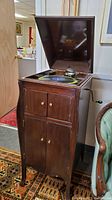 Front view of the vintage Victor Victrola cabinet with lid open revealing turntable.