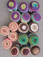Photo showing all 17 yarn skeins arranged, showcasing various vibrant colors and different brands.