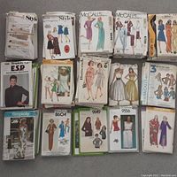 Photo showing stacks and rows of vintage ladies sewing patterns from various brands with illustrated covers depicting 1970s fashion styles.