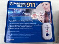 Front of the box showing the Guardian Alert 911 emergency alarm device and usage information.