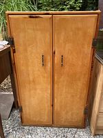 Closed wooden cabinet with two doors and metal handles