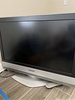 Front view of the Panasonic 31-inch television showing the screen and swivel base with remote.