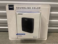 Front of sealed Bose SoundLink Color speaker box showing product image and branding.