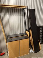 Disassembled black wooden parts including panels and standing structure for IKEA Hemnes day bed