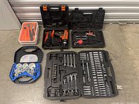 Full overview of the mixed tool lot showing all included case sets and cordless drill