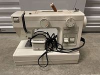 Front view of Pfaff Hobby 309 sewing machine including power cord and foot pedal