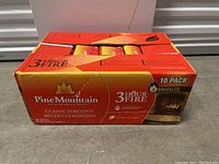 Front view of a large orange and yellow box of Pine Mountain Classic Firelogs 10 pack showing branding and burn time of 3 hours.