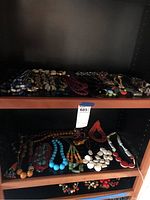 Top shelf showing assorted chunky and colorful bead necklaces.