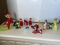 Overall view of large planter elf and an assortment of small elf figurines on shelf