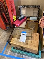 Overview of stacked and arranged empty jewelry boxes of various colors, sizes, and materials