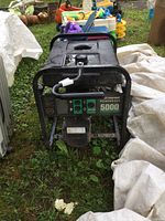Front view of black steel frame generator showing control panel and fuel tank