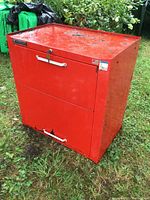 Front view showing red tool chest with two drawers, surface wear, and Mastercraft logo badge.
