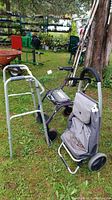 Side view of three mobility aids: folding wheeled walker with seat, static walker, and two-wheel bundle buggy with fabric bag, showing condition and wear.