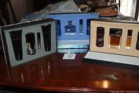 Photo of three Maxx Monet men's fragrance sets including Dynamic, Aspire, and Change boxes displayed on table.
