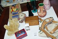 Overview of the lot showing various items including vases, marionettes, puppets, a small clock, and collectible boxes.