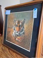 Full framed tiger print showing the entire piece with wood frame and black matting.