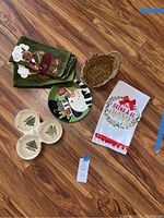 Photo showing all items including kitchen towels, ceramic serving dish, snowman plate, and woven basket on wooden floor