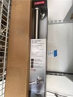 Photo of boxed Delta 18 inch Greenwich grab bar showing packaging details and brand label