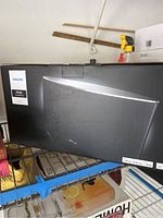 Box of Philips Fidelio SoundAvia wireless speaker shown on metal shelf in garage setting