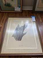 Full view of framed Downy Woodpecker print by Ray Harm with mat and gold frame, showing two woodpeckers on a tree stump, signed by artist.