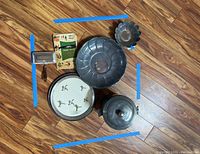 Top-down photo of all silverplate servingware items arranged on floor with visible tarnish and wear