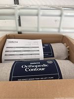 Two Sutera Orthopedic Contour memory foam pillows in box with invoice.