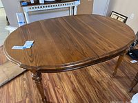 Top view of the oval traditional wood dining table with two leaves in place.