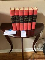 Front view of six volumes of Winston Churchill's The Second World War series on half moon table.
