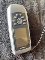 Garmin GPSmap 78sc handheld GPS unit with screen and physical button controls.